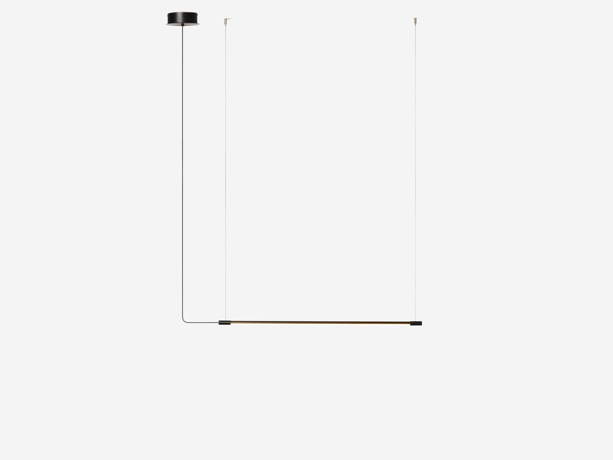 Small slim black pendant lamp with light on side view